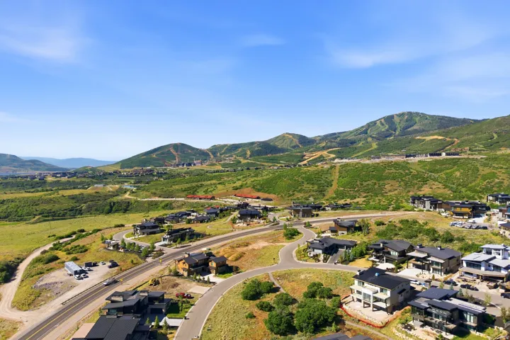 Aerial representation of the expansive mountain landscape featuring residential properties set amidst rolling green hills