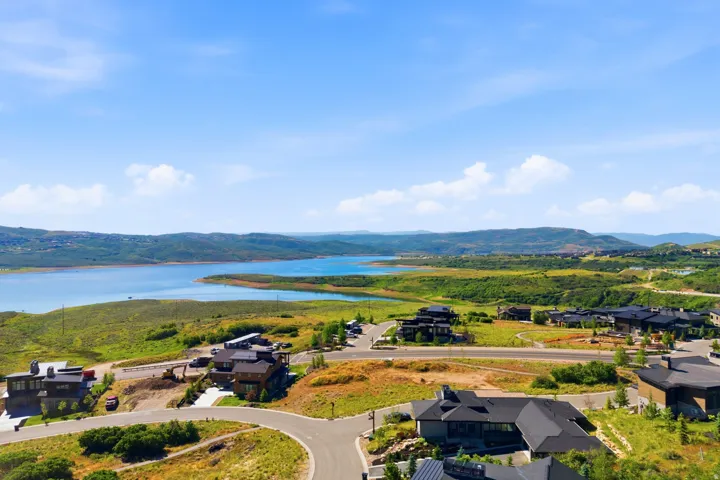 Expansive water body surrounded by lush green and golden hillsides