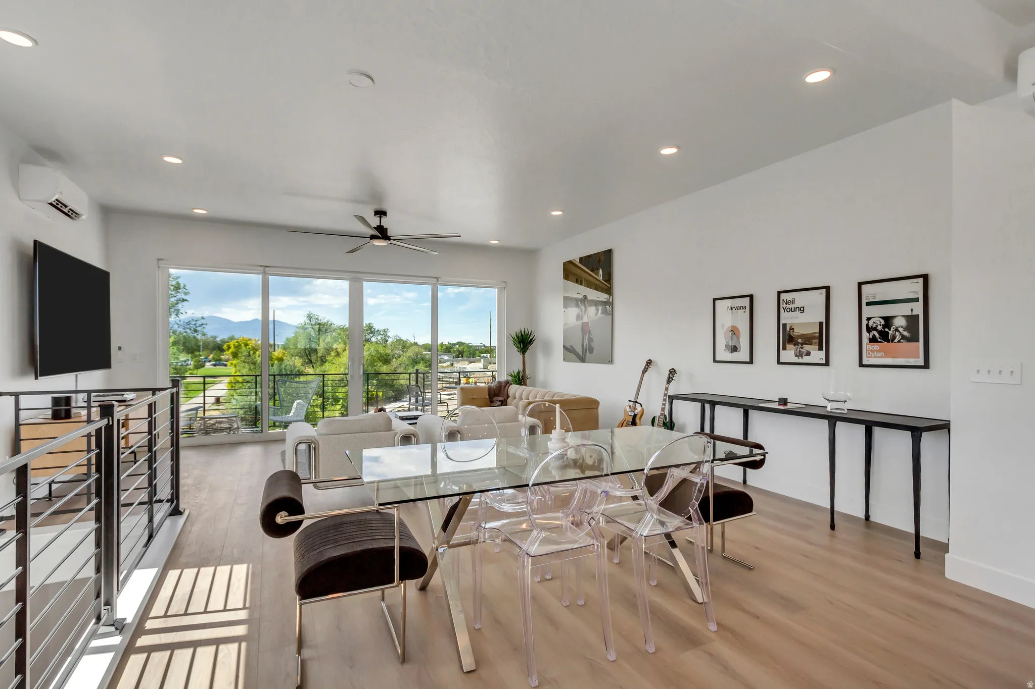 Open-concept living area with wood-finish flooring, a contemporary ceiling fan, and recessed lighting