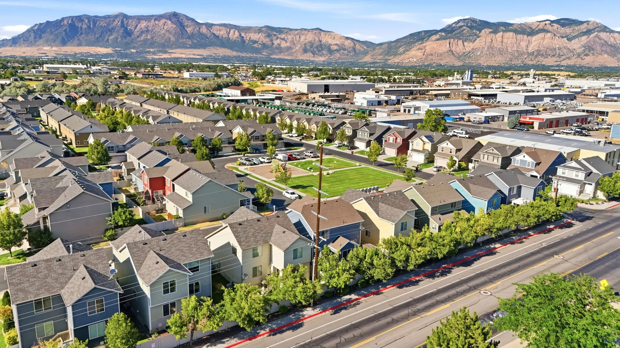 Aerial perspective of a residential community featuring varied architectural styles and a central green space