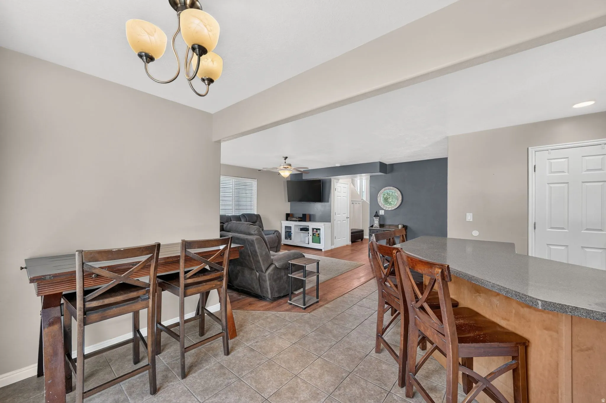 Kitchen bar seating with a light-toned countertop and wood-finish cabinetry