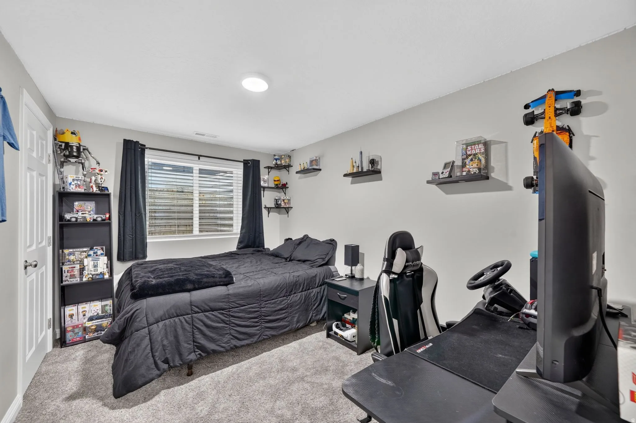Bedroom featuring light gray walls and plush gray carpeting