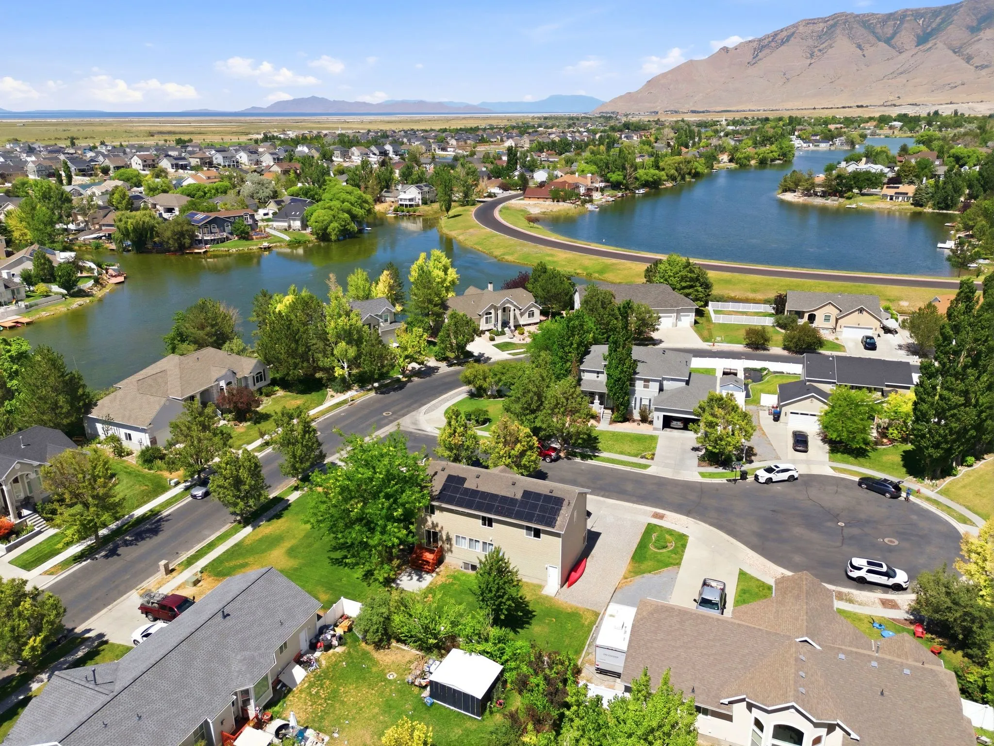 Aerial perspective showcasing a residential community with a prominent lake