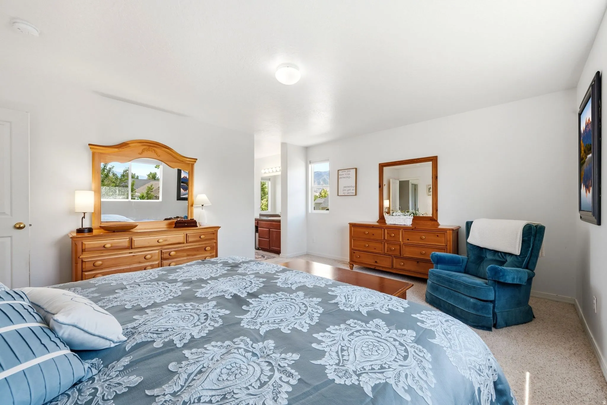 Bright interior space featuring light-toned walls and carpeted flooring