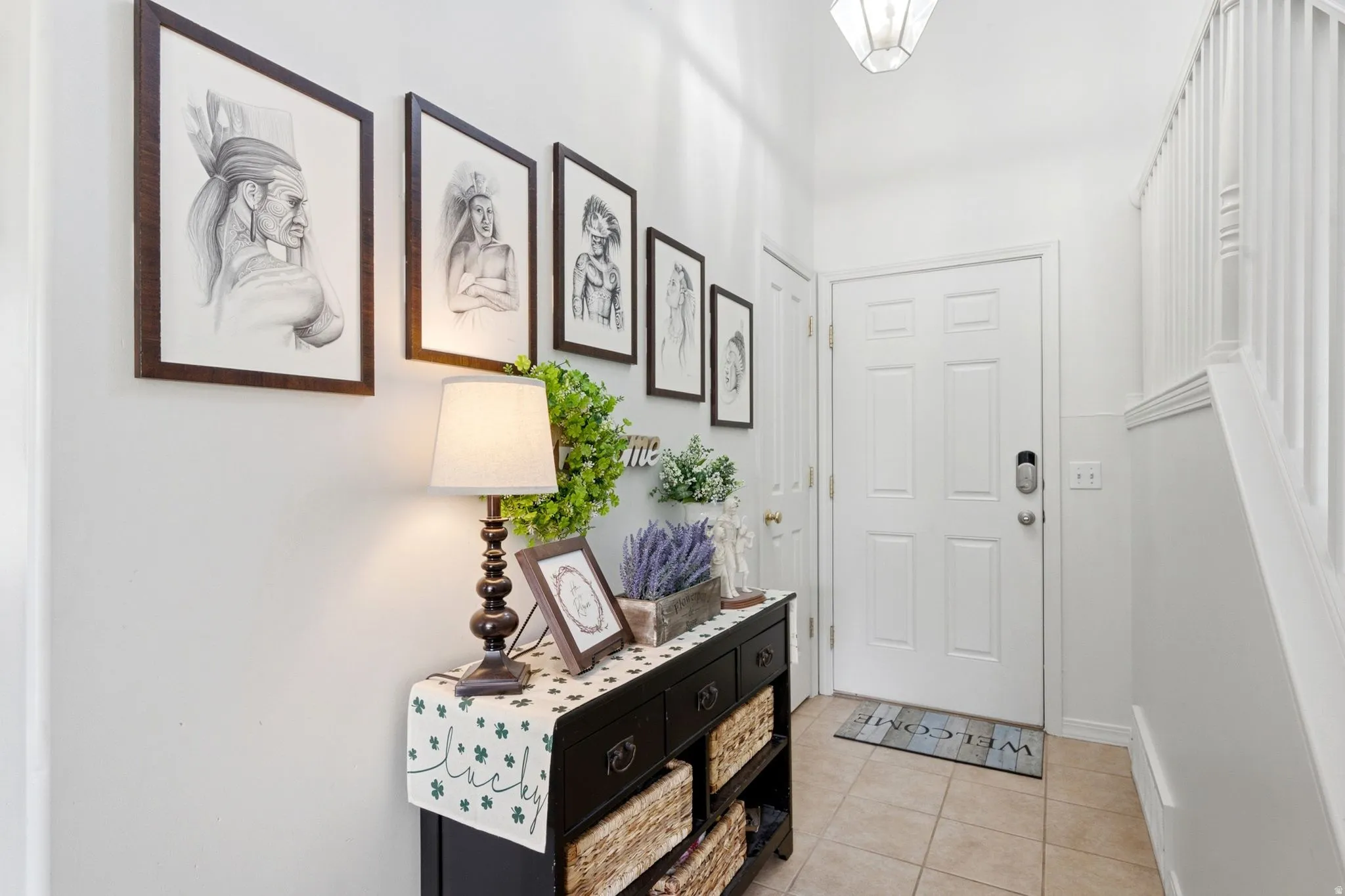 Entryway featuring a white paneled door with smart lock, tile flooring, and white painted walls