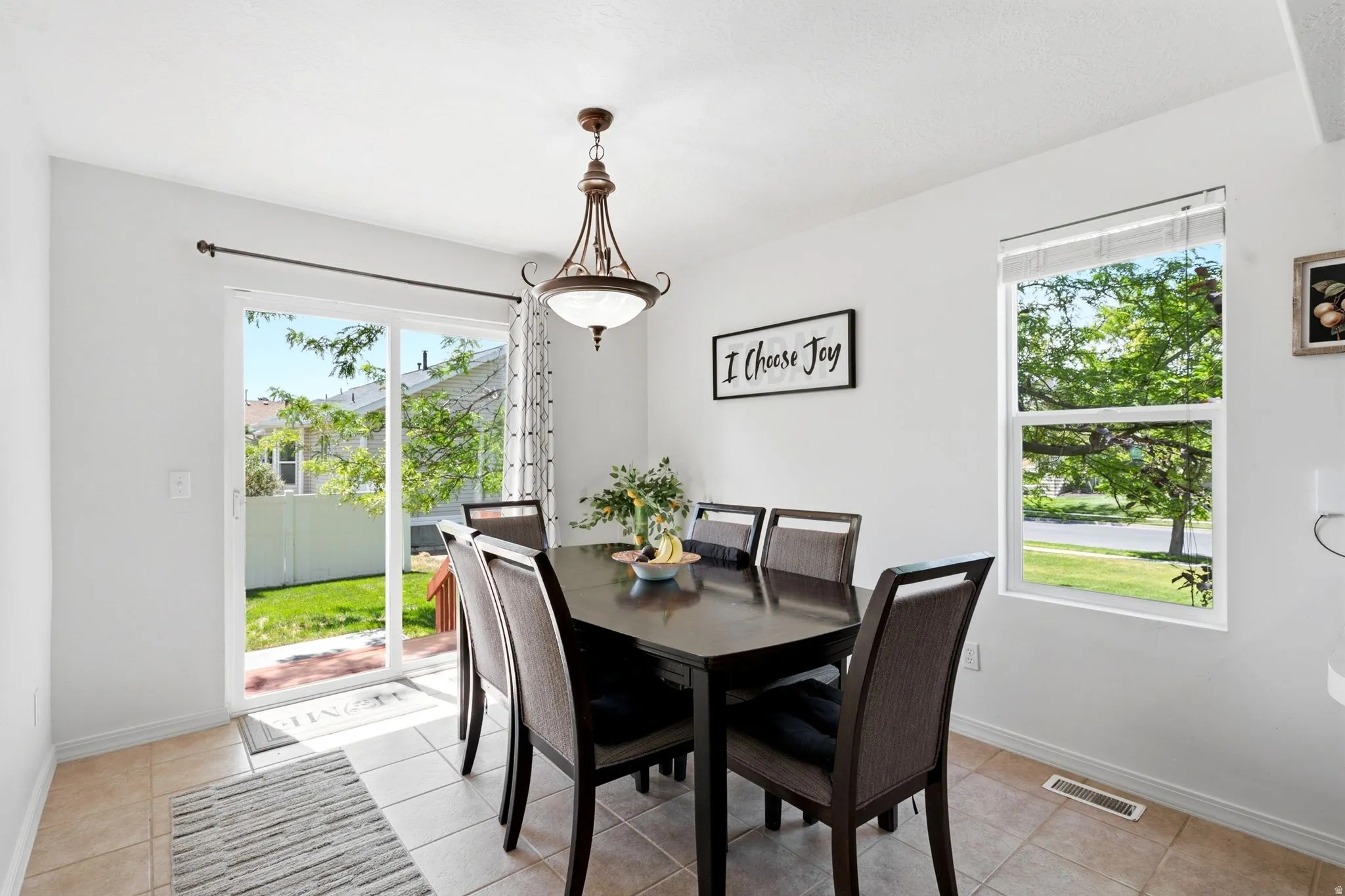 Bright dining space featuring a sliding glass door to the exterior and a large window