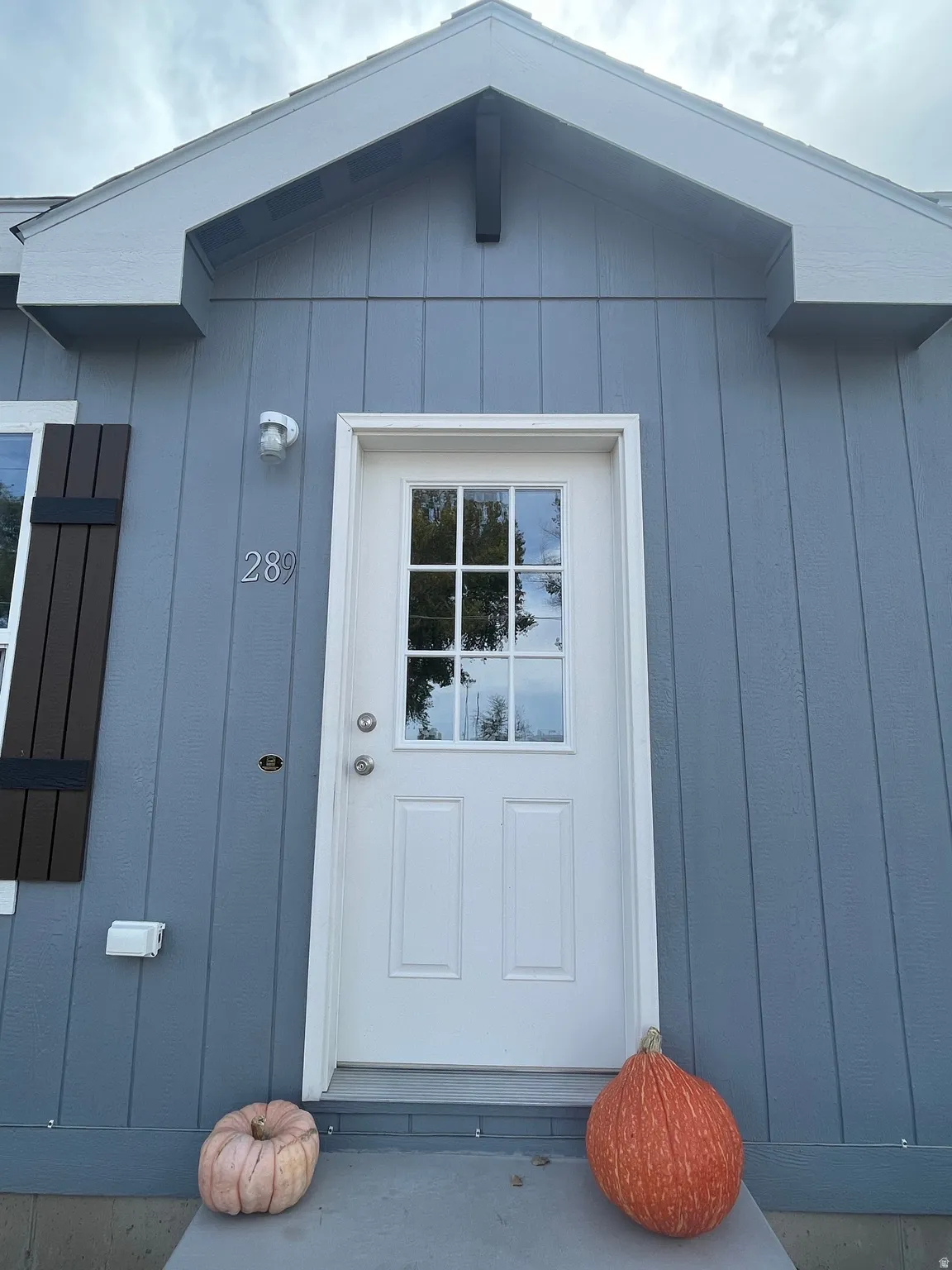 Light blue board and batten siding with white trim