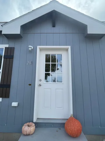 Light blue board and batten siding with white trim