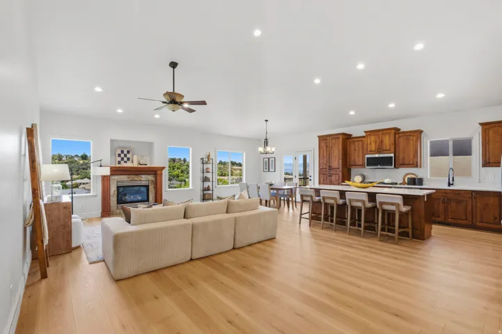 Open concept living area featuring wood-finish flooring, recessed lighting, and a ceiling fan