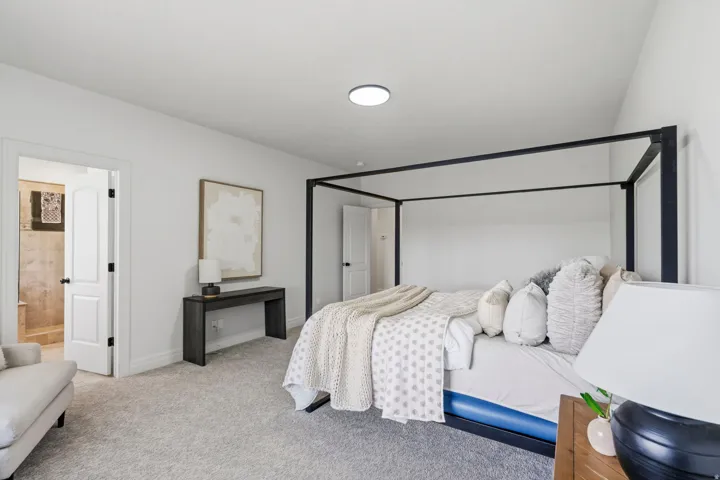 Carpeted bedroom featuring white walls and a contemporary flush-mount ceiling light