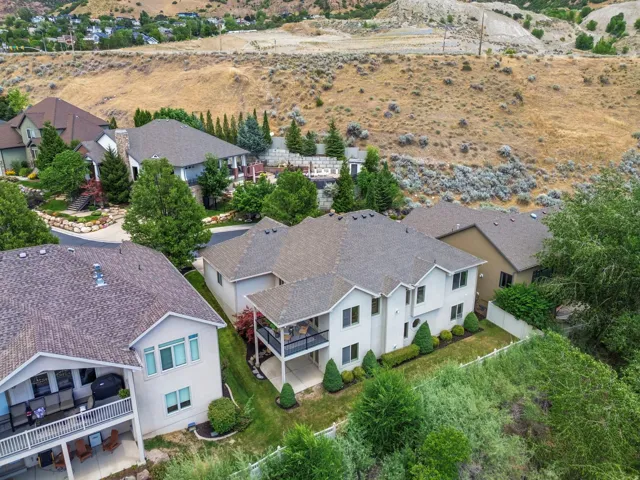 Two-story residence featuring a covered upper-level deck and a lower-level patio