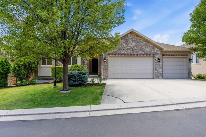 Stone facade with a two-car garage and a separate single-car garage