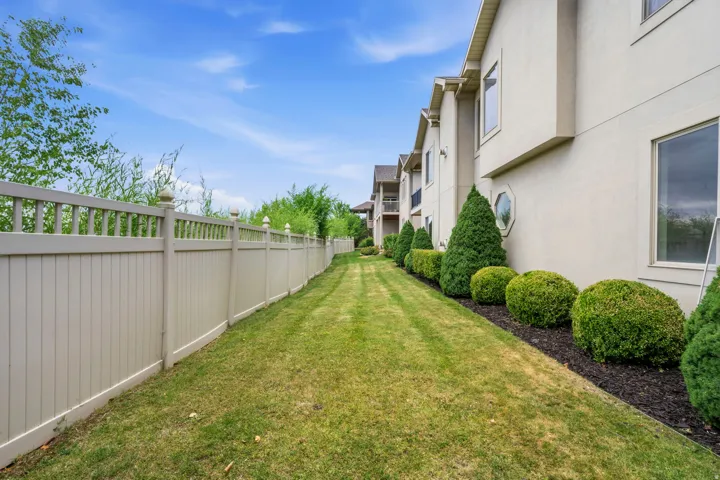 Expansive side yard featuring a manicured lawn