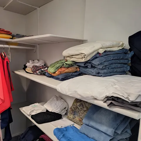 White shelving units with integrated garment rods