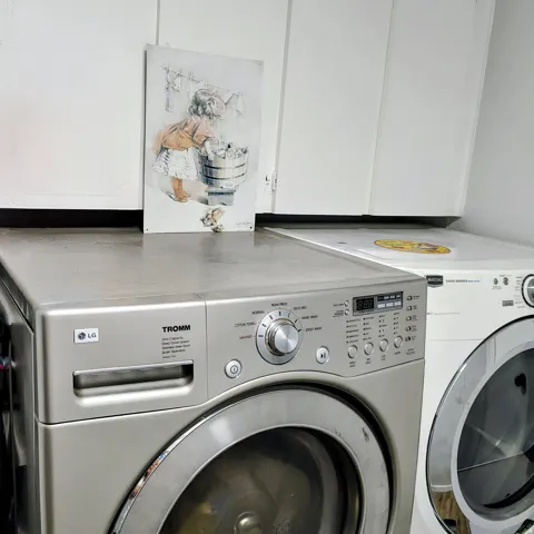 Laundry area featuring upper cabinetry, a counter surface, and space for appliances