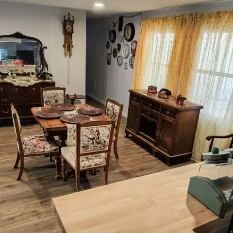 Open-concept room featuring wood-finish flooring, recessed lighting, and white paneled walls