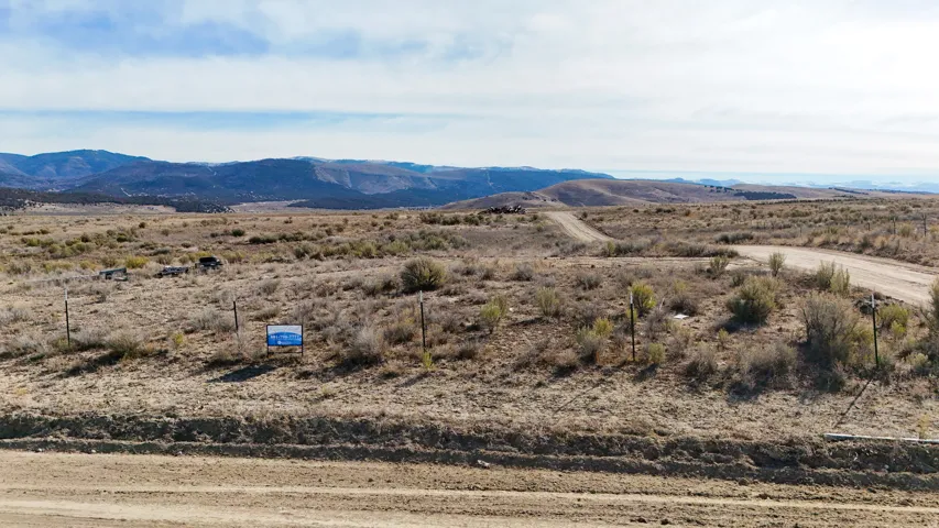 Expansive undeveloped land featuring natural terrain and distant mountains