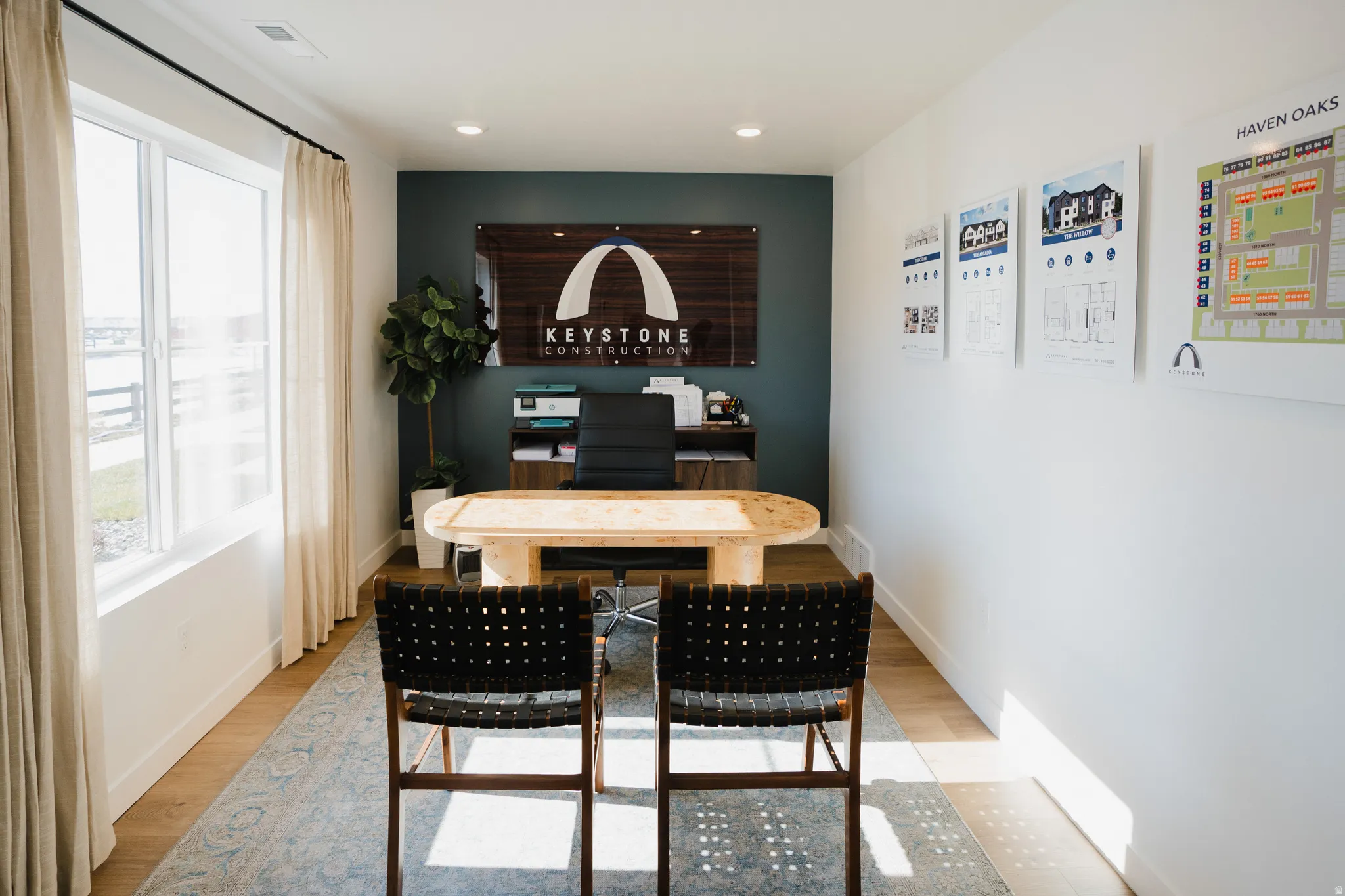 Office space featuring a large window, recessed lighting, and wood-finish flooring