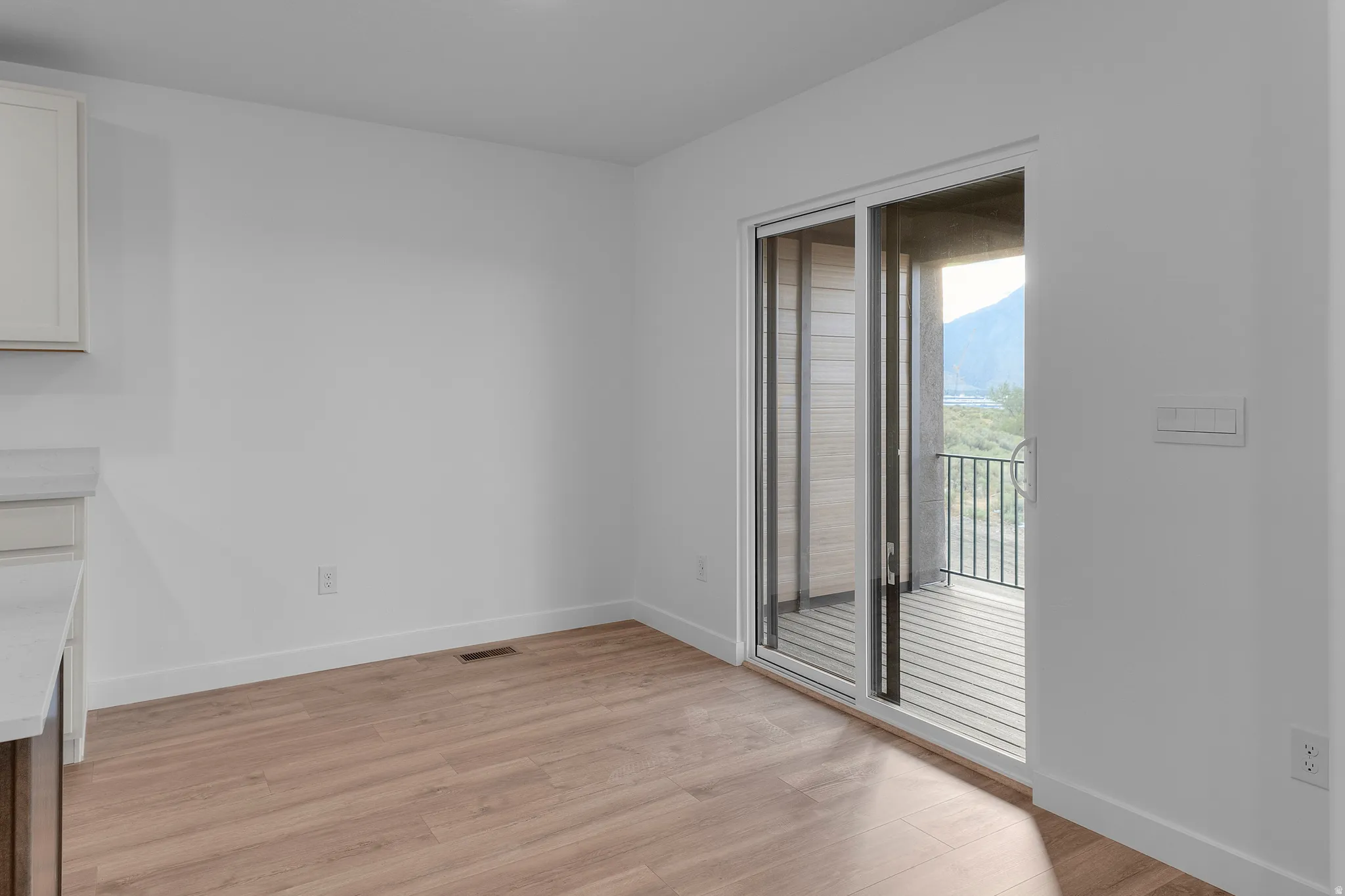Light wood-finish flooring complements the white walls and trim