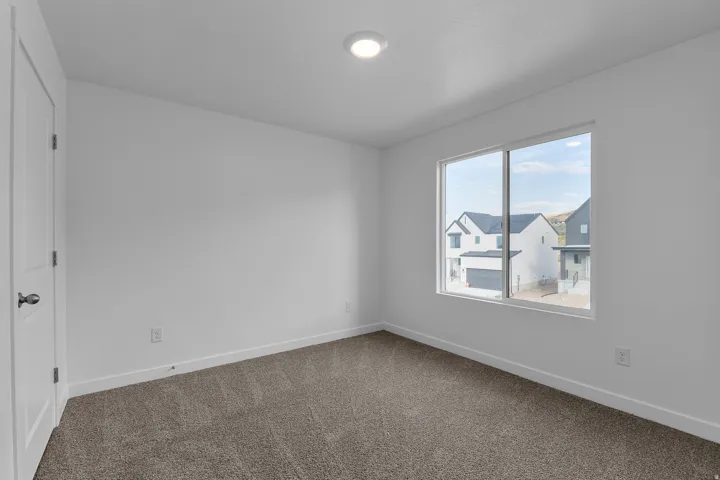 Bright interior space featuring a window with a neighborhood backdrop