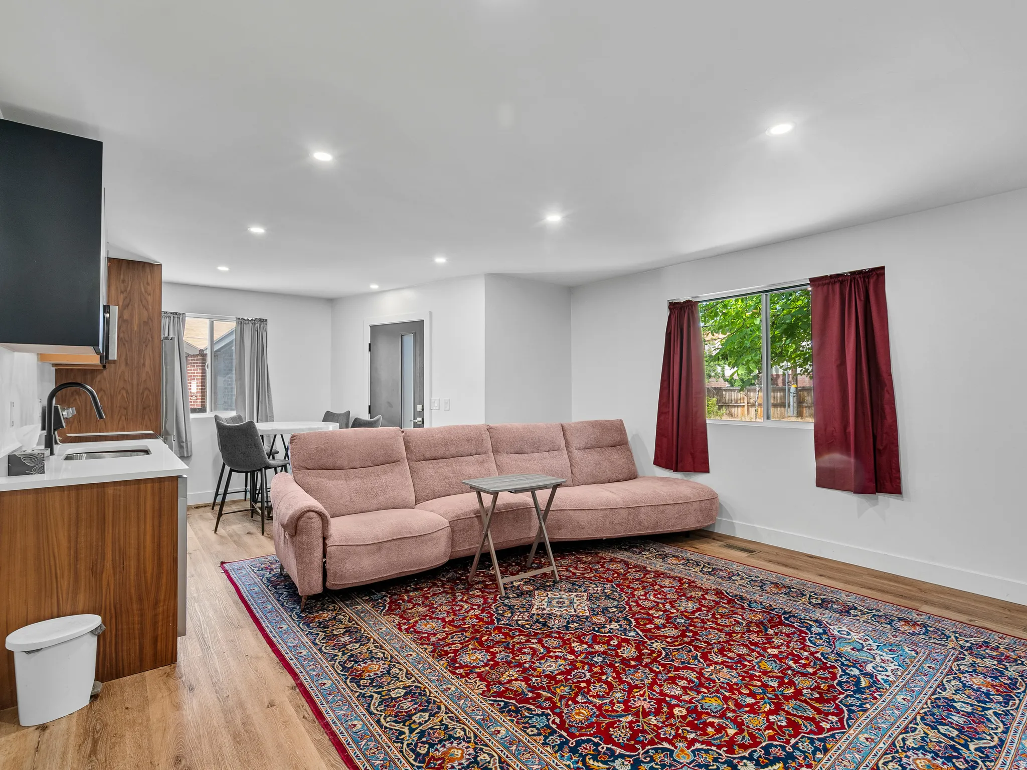 Open-concept living area with light wood-finish flooring