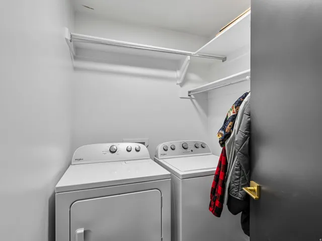 Laundry area featuring built-in shelving and a clothing rod