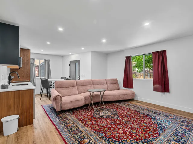 Open-concept living area with light wood-finish flooring