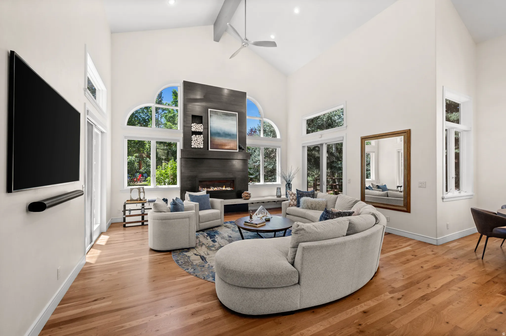 Vaulted ceilings with exposed beams and a ceiling fan
