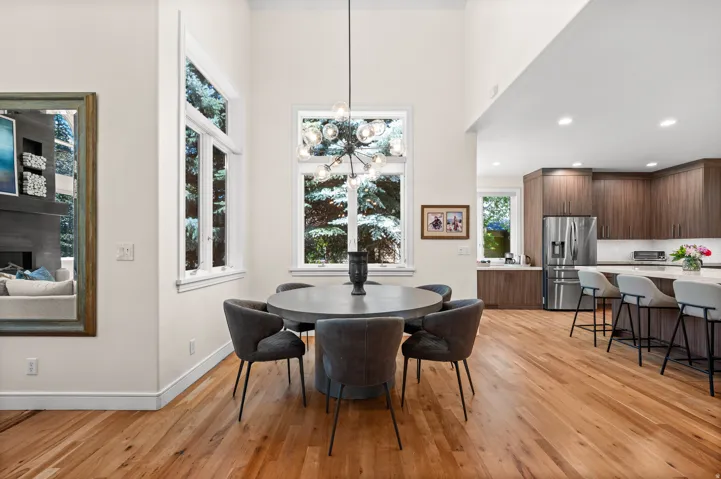 Open-concept dining and kitchen area with light wood-finish flooring