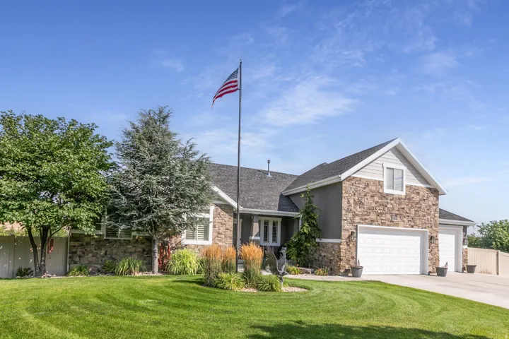 Stone veneer and siding exterior with a two-car garage