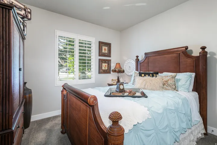 Interior room featuring white walls, gray carpeting, and white baseboards