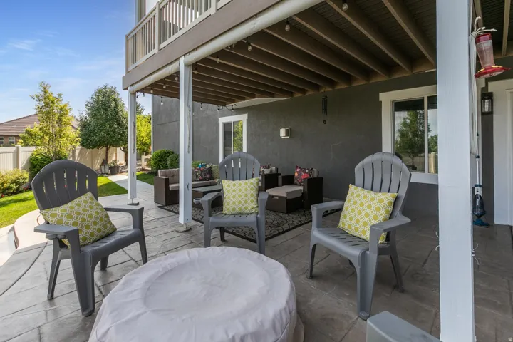Lower-level patio featuring stamped concrete, string lighting, and a covered ceiling