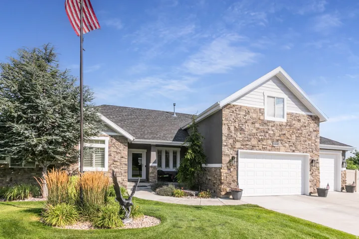 Stone and siding exterior with an attached two-car garage