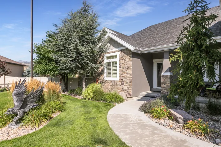 Stone and stucco exterior with an asphalt shingle roof