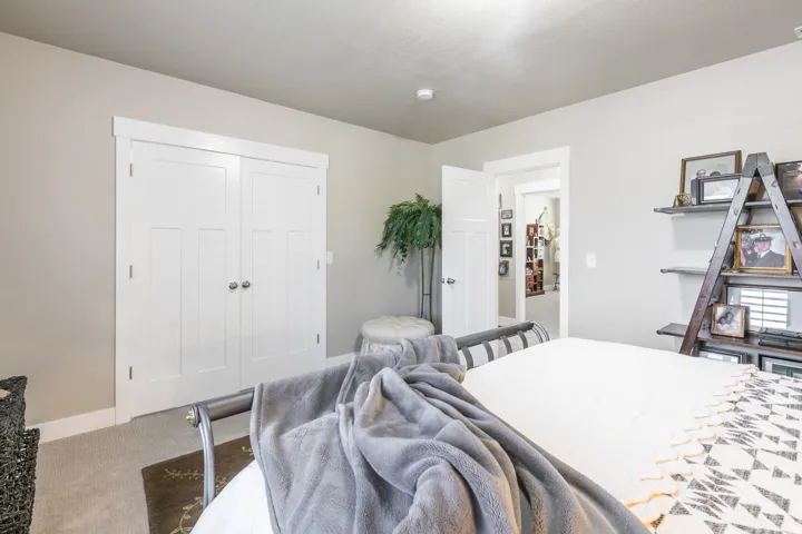 White paneled bi-fold closet doors with brushed nickel hardware