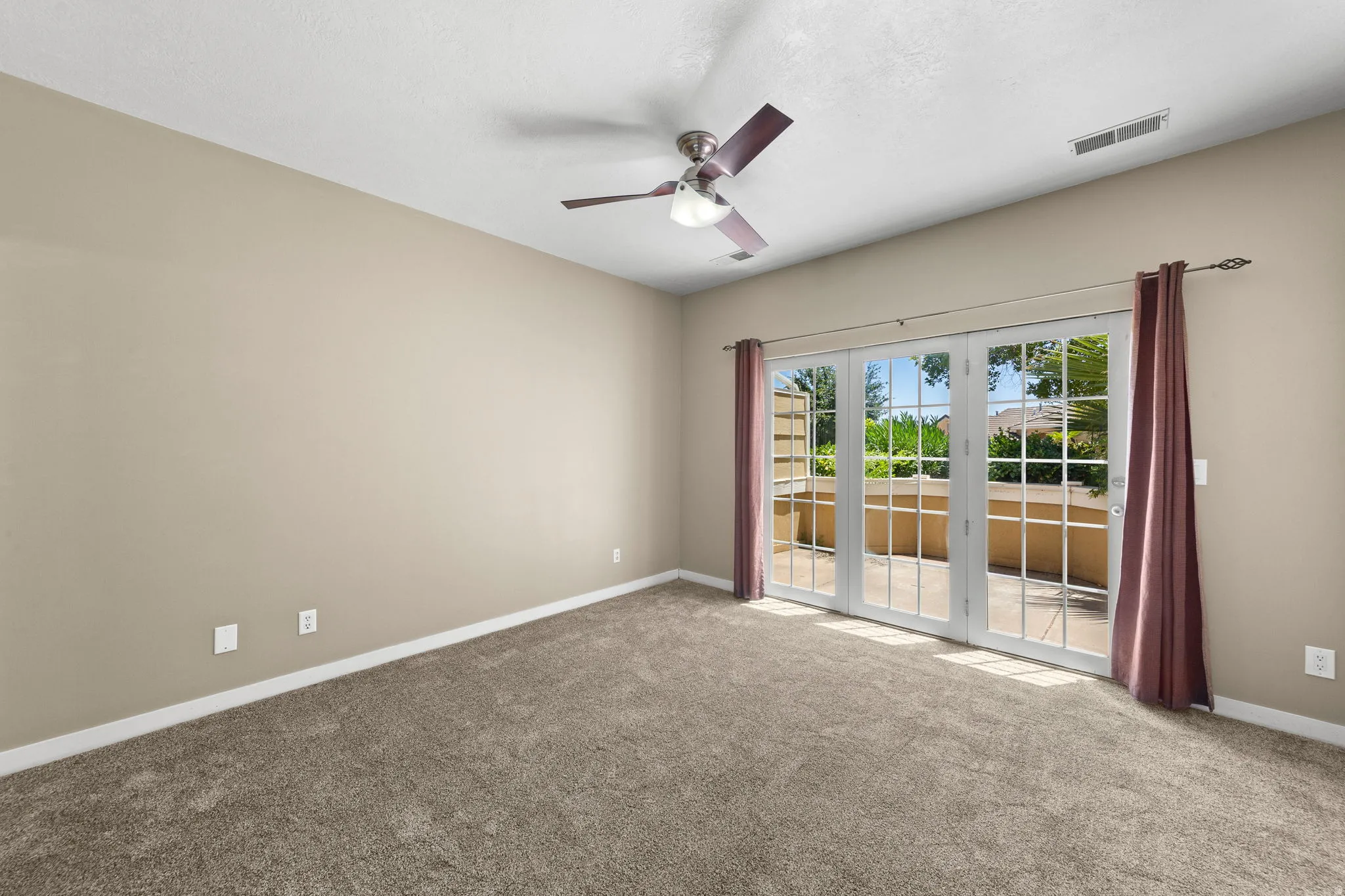 Spacious room featuring neutral carpeting and light beige walls