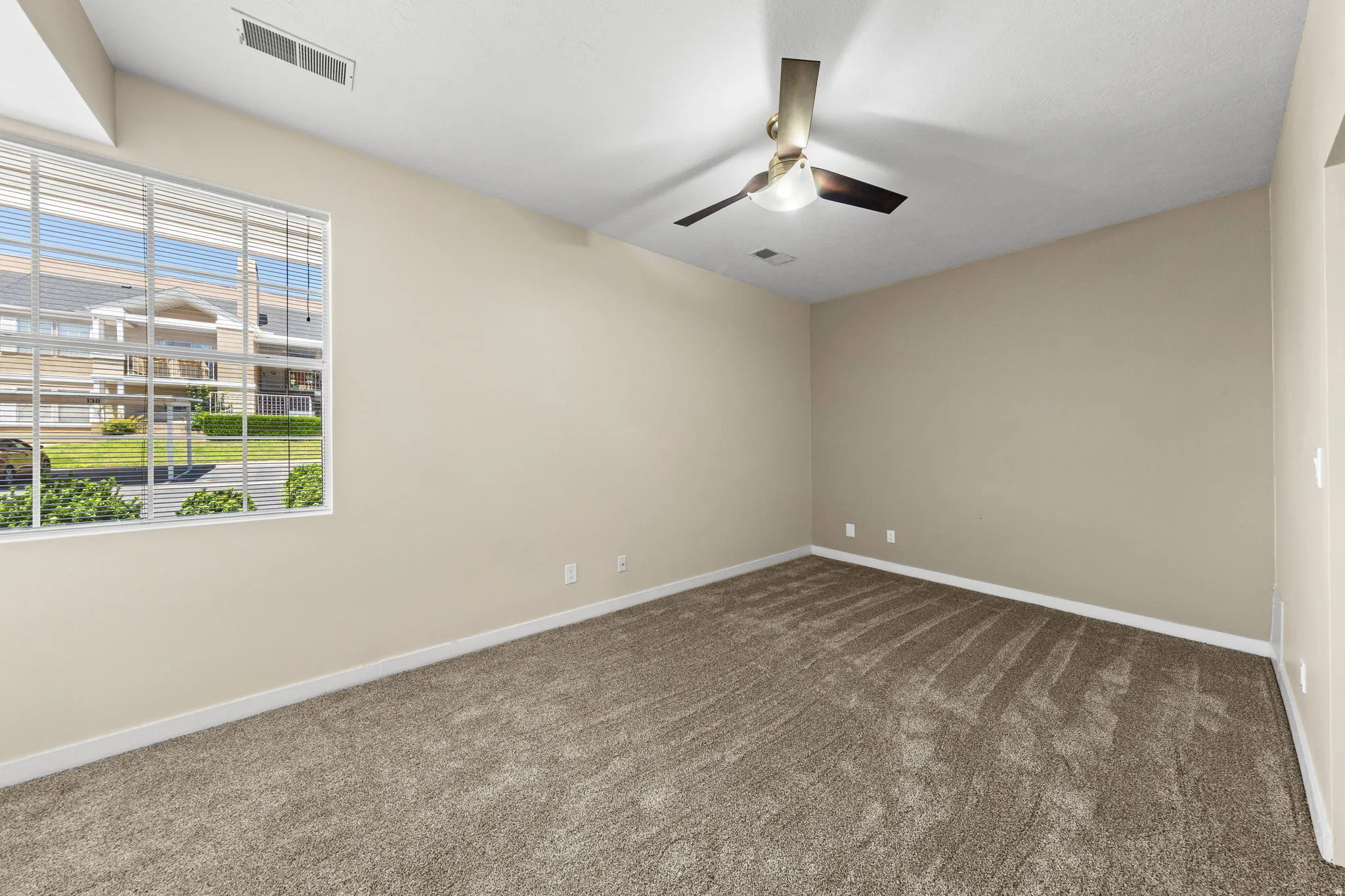 Neutral-toned carpeting throughout the room