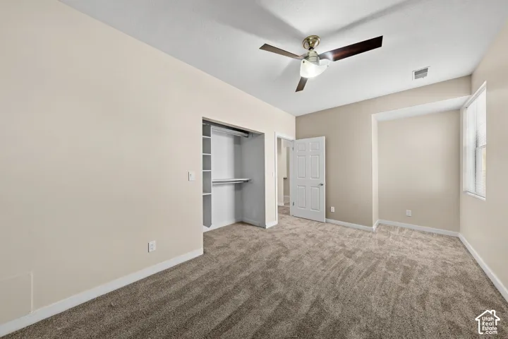 Carpeted room with neutral wall tones and white trim