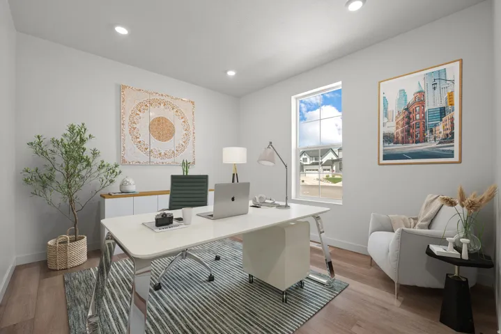 Recessed lighting illuminates this room, featuring wood-finish flooring and a window with white trim