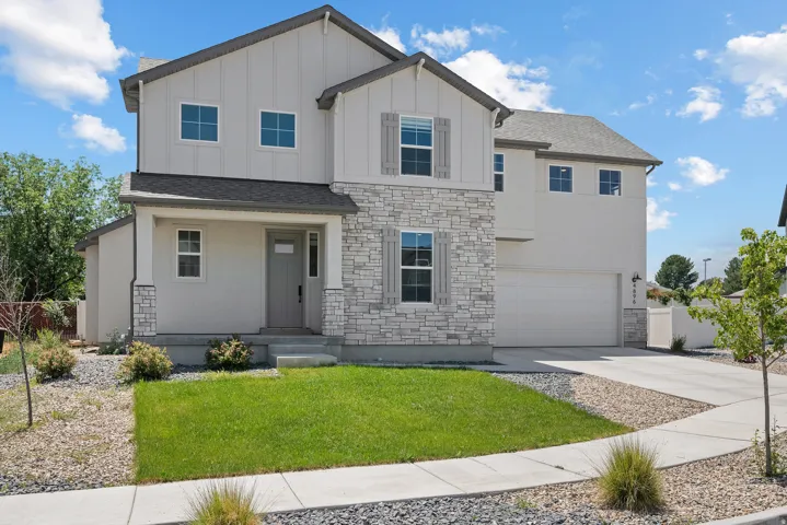 Contemporary two-story exterior featuring a mix of horizontal siding, vertical board-and-batten accents, and stone veneer