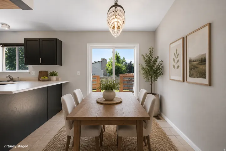 Kitchen featuring dark cabinetry, light countertops, and a window above the sink