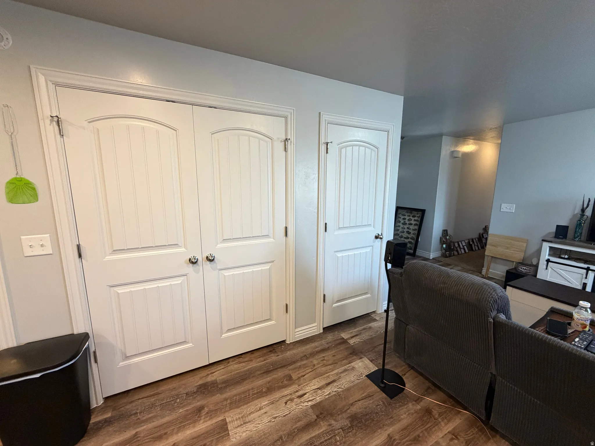 Wood-finish flooring throughout, complemented by light-colored walls and white trim