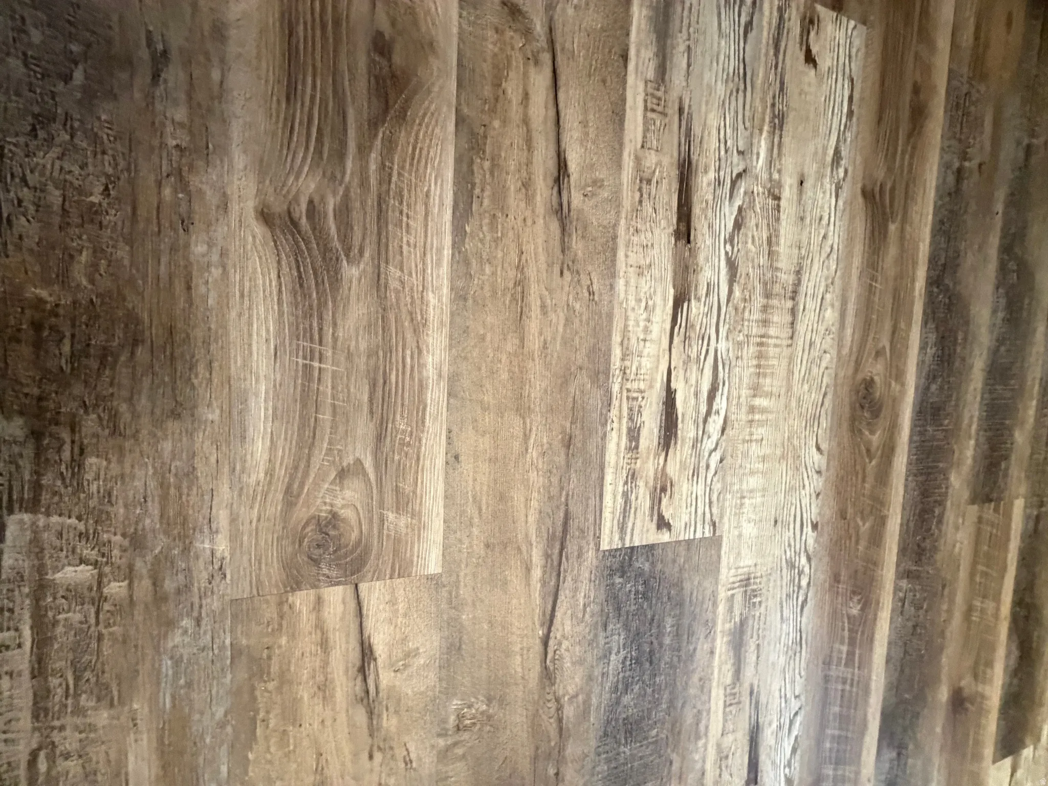 Wood-finish flooring with varied plank widths and natural wood grain patterns