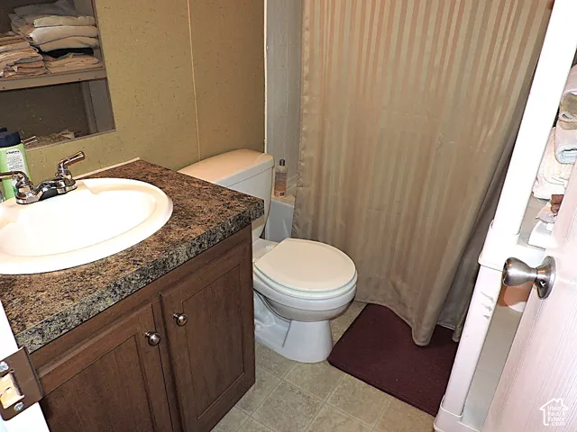 Bathroom vanity featuring a built-in sink and laminate countertop