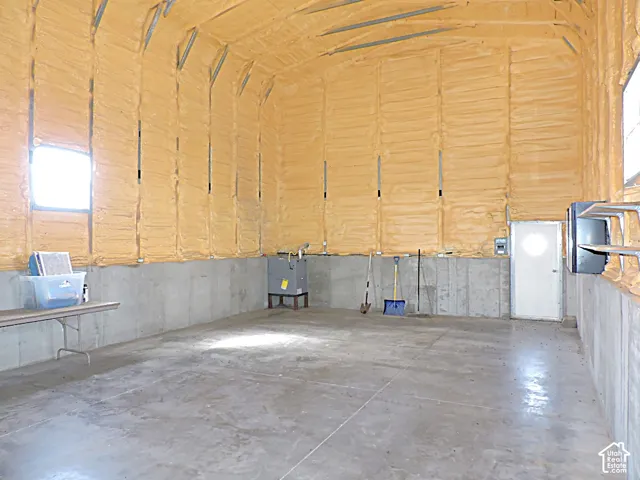 Concrete flooring, concrete perimeter walls, spray foam insulation, single window, metal entry door