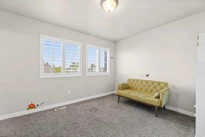 Neutral wall tones complement the durable gray carpet