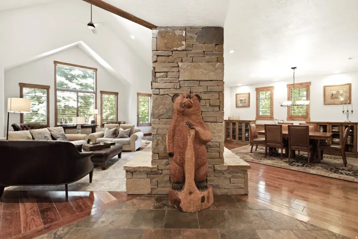 Vaulted ceilings with exposed wood beam and ceiling fan