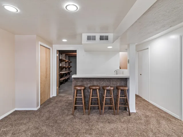 Built-in bar with a light-colored countertop and integrated sink