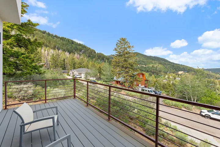 Spacious outdoor deck with composite wood-finish flooring and cable railings