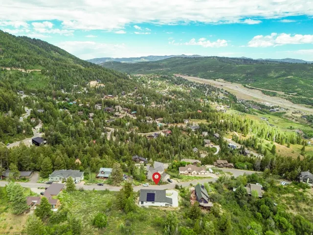 Mountainous landscape featuring residential properties and extensive tree coverage
